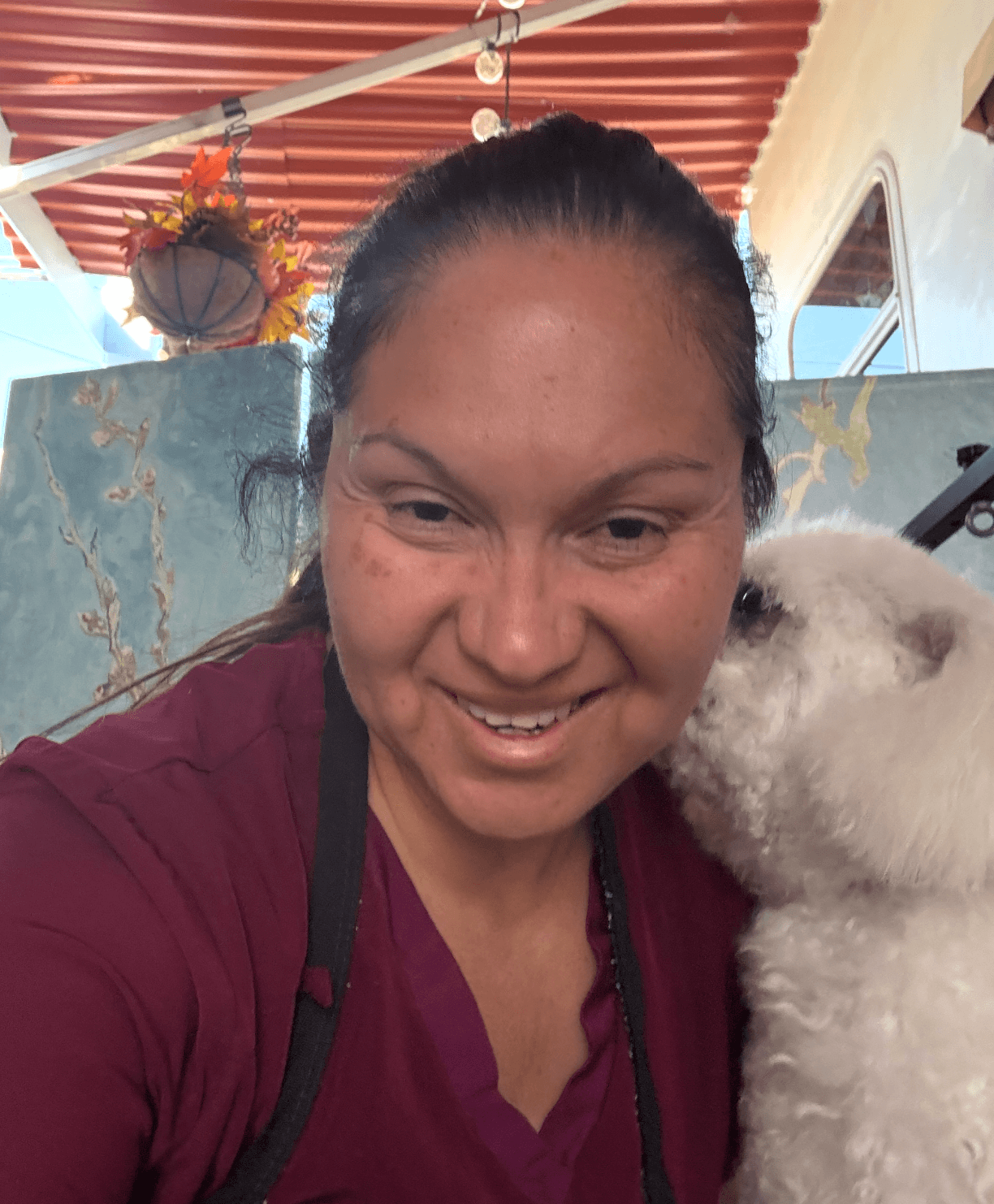 Yolis smiling with a client dog